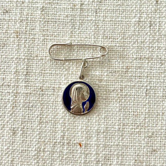 Silver safety pin with Child Mary medal