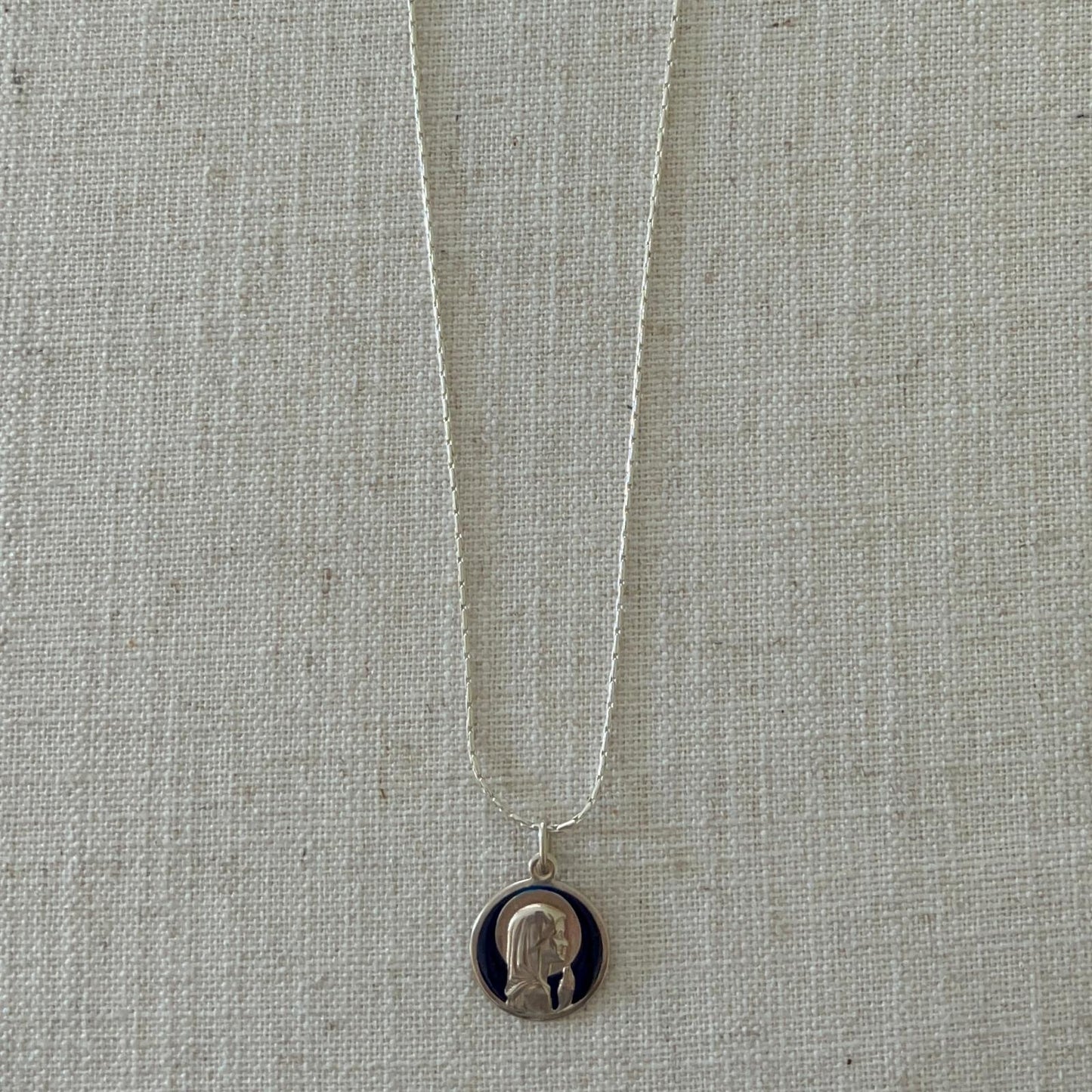 Child Mary with blue enamel medal with silver chain